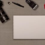 digital camera, notebook, memory card, hotshoe-mounted flash, sd card, photographic equipment, table, camera brush, modern, deco, writing pad, new, hobby, leisure time, rose flower, taking photos, lens, notes, copy space, empty, rose, template, scrapbook